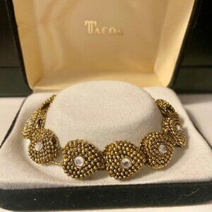 Tacoa stretch bracelet with hearts.  Gold tone in original box